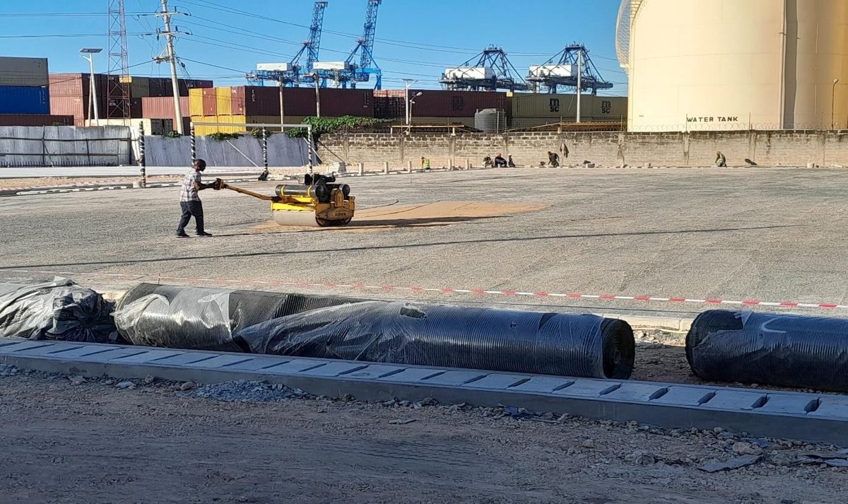 Rolling the base before turf placement