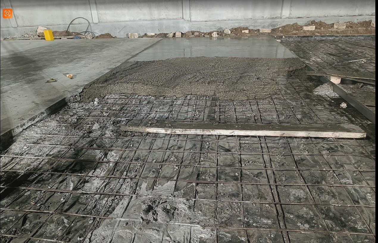Wet concrete screeded over reinforcement mesh
