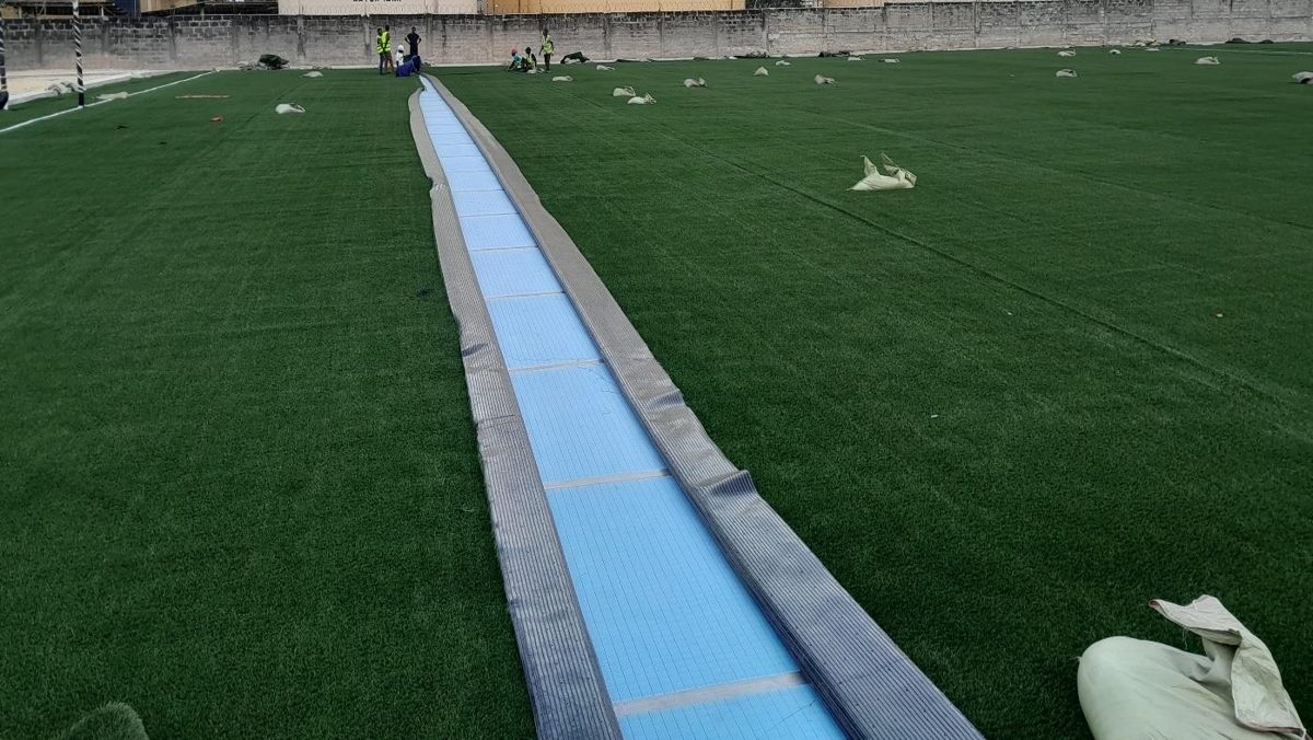 Turf seam being glued